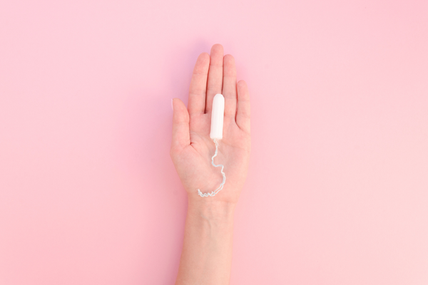 hand with tampon